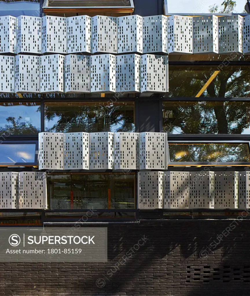 The Livity School, London, United Kingdom. Architect Haverstock Associates LLP, 2013. Facade detail with dark brick, stainless steel cladding and windows.