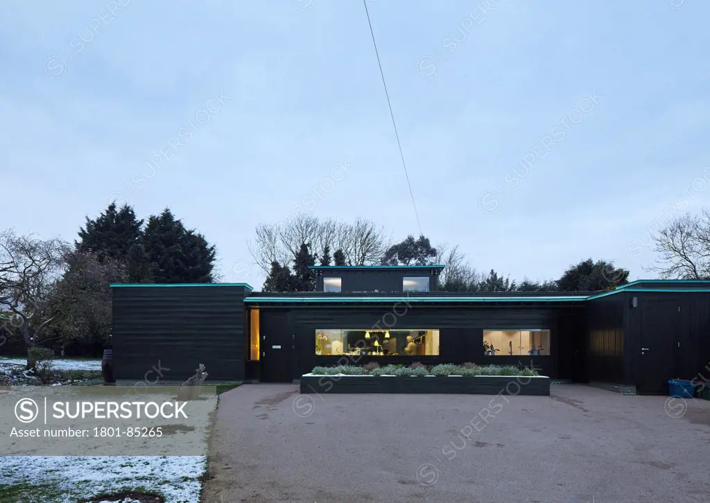 Crowbrook House, Harlow, United Kingdom. Architect Knox Bhavan Architects LLP, 2012. Front elevation with driveway in winter.
