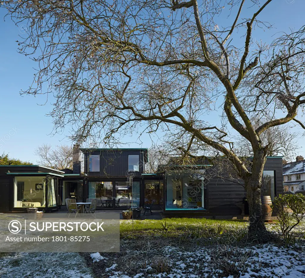 Crowbrook House, Harlow, United Kingdom. Architect Knox Bhavan Architects LLP, 2012. View from garden to house in winter.
