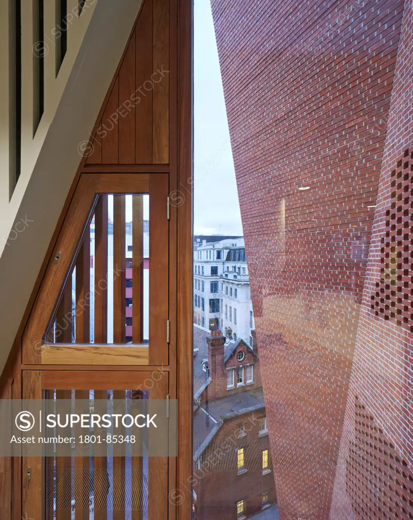 London School of Economics,Saw Swee Hock Students Centre, London, United Kingdom. Architect O'Donnell & Tuomey, 2014. View from interior to outer brick facade and timber window shutters.