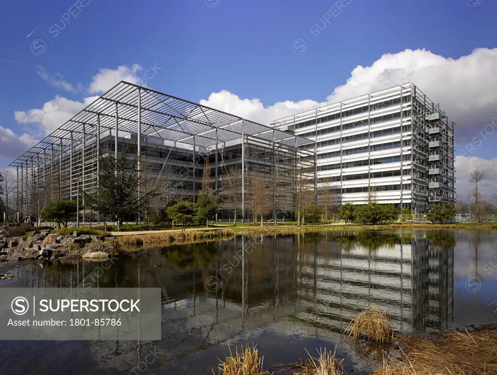Chiswick Park, London, United Kingdom. Architect Rogers Stirk Harbour + Partners, 2013. Overall exterior view with lake in foreground.