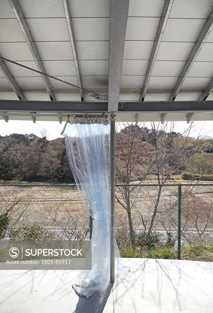 Home for all,Miyato Island, Miyato, Japan. Architect SANAA, 2013. Home-for-All, exterior view of canopied terrace showing clear plastic curtains.