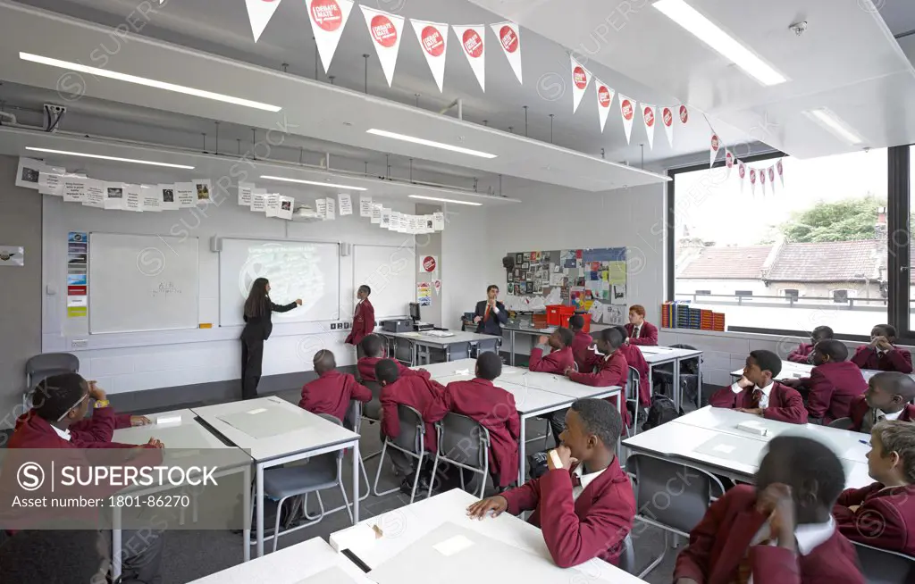 St Thomas the Apostle College, London, United Kingdom. Architect Allies and Morrison, 2013. English classroom on upper level with students.