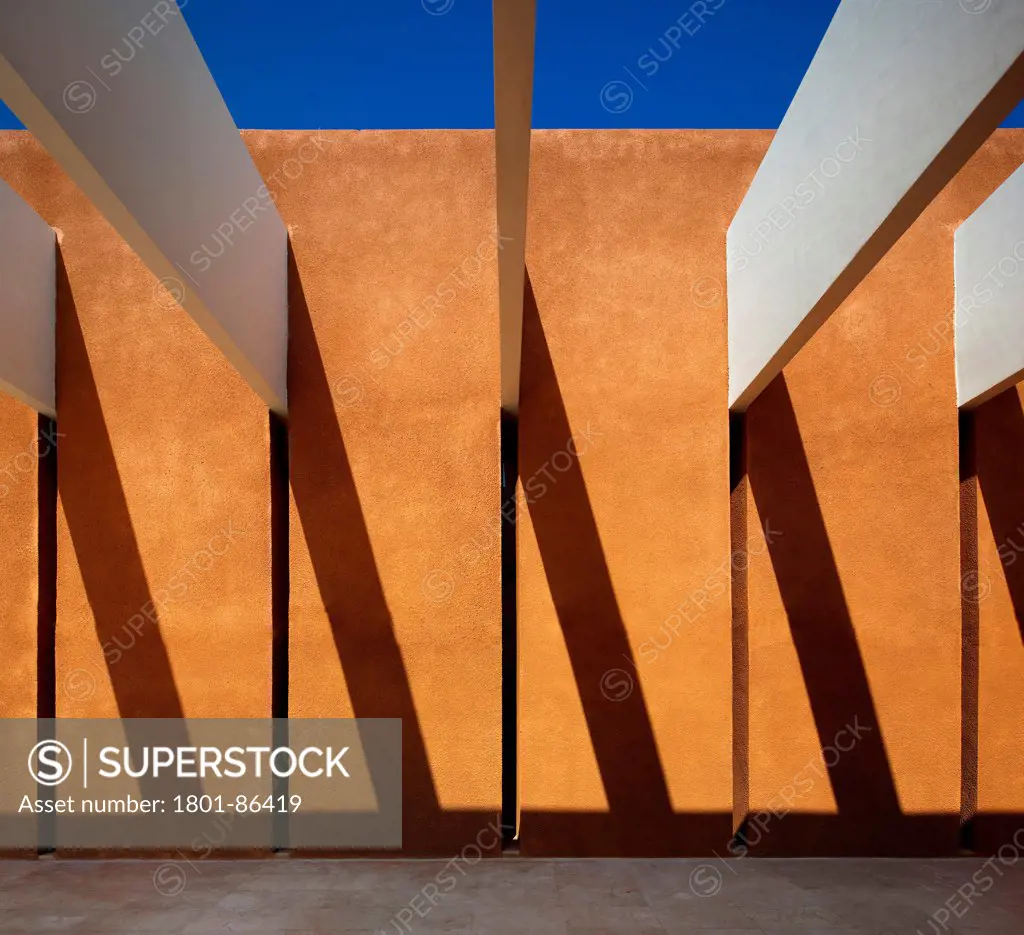 Taroudant University, Taroudant, Morocco. Architect Saad el Kabbaj, Driss Kettani, Mohamed Amine Siana, 2011. Orange coloured wall with shadow projection.