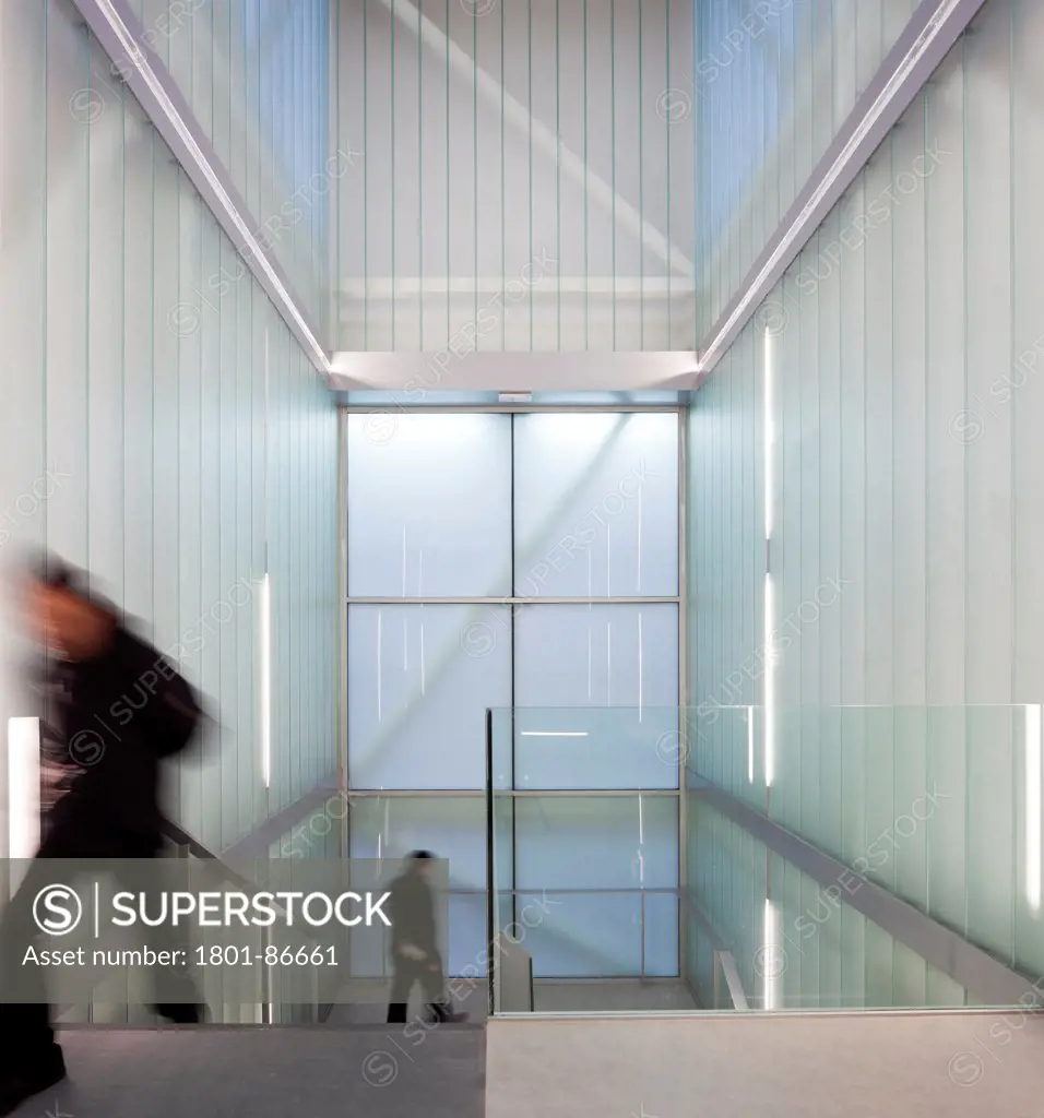 Civic Centre in Palencia, Palencia, Spain. Architect Exit Architects, 2012. Glass stairway with figures moving.
