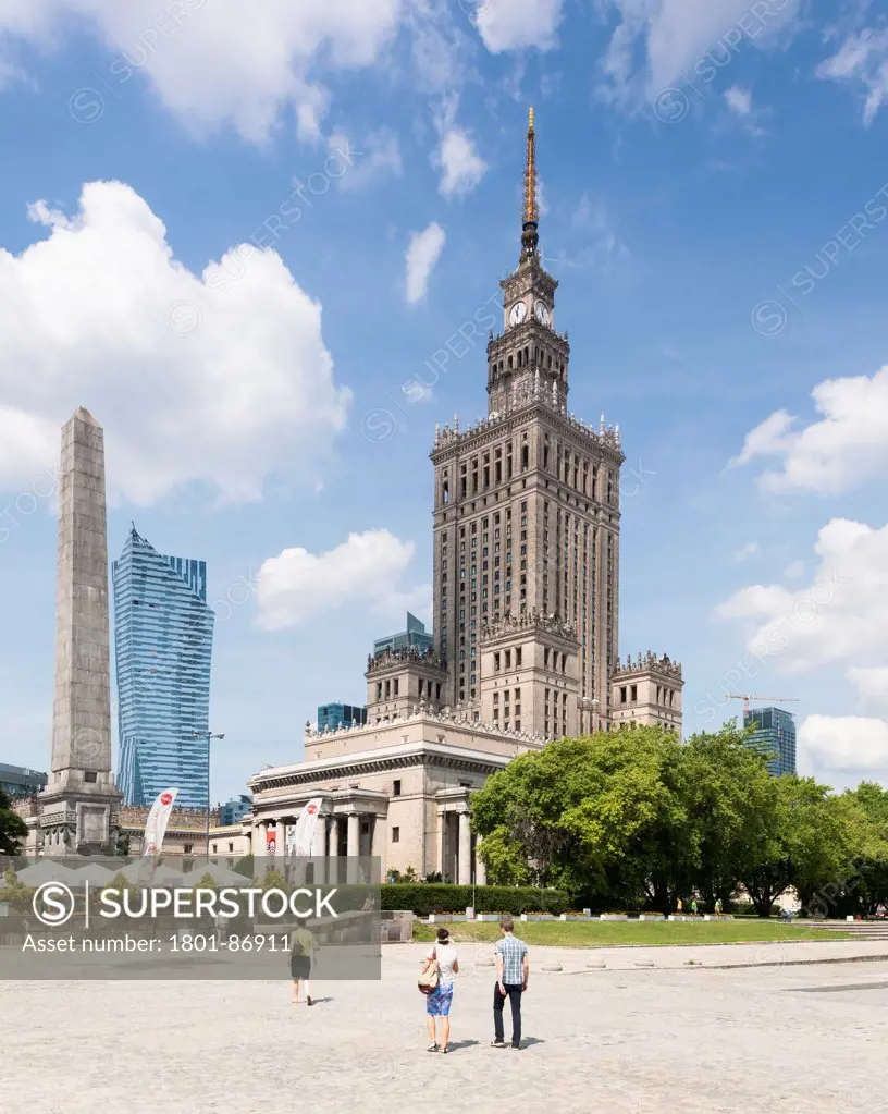 Warsaw Cityscape, Warsaw, Poland. Architect Various, 2013. Stalinist Palace of Culture with obelisk and the new office building by Daniel Libeskind beyond.