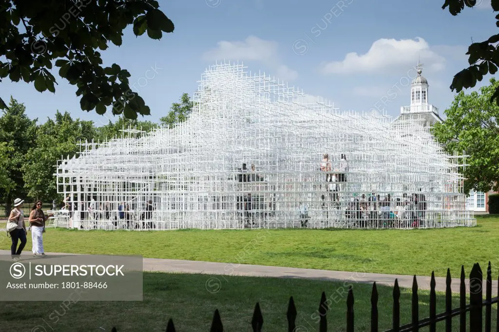 Serpentine Pavilion 2013, London, United Kingdom. Architect Sou Fujimoto, 2013. View of Serpentine Pavilion with Serpentine gallery in in background.