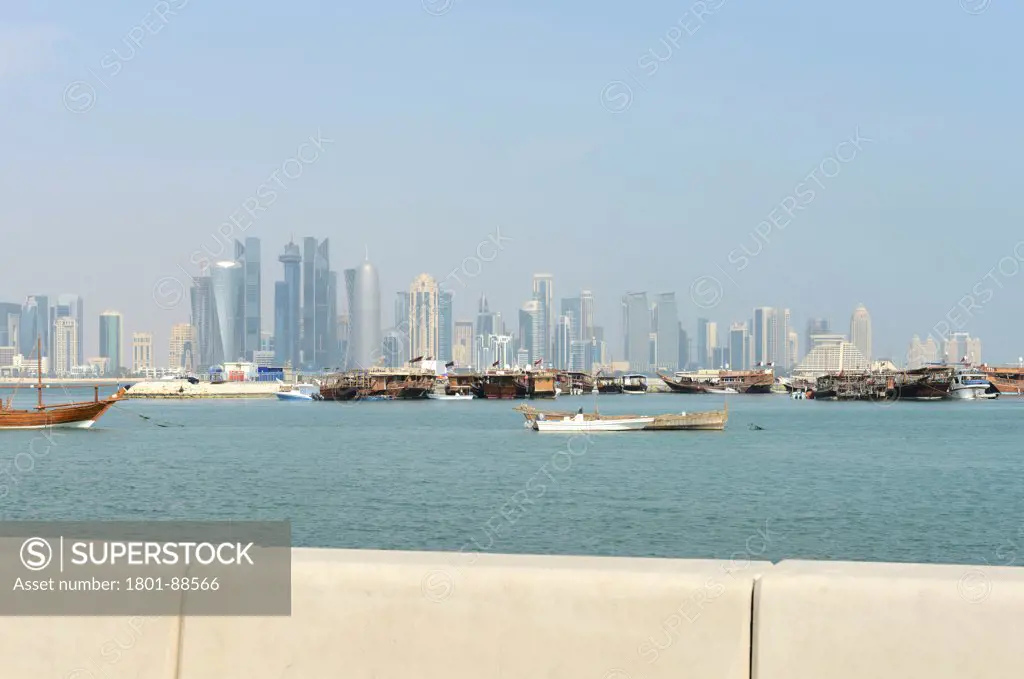 Burj Qatar, Doha Tower, Doha, Qatar. Architect Ateliers Jean Nouvel, 2012. View of Doha's Skyline through the bay, with boats.