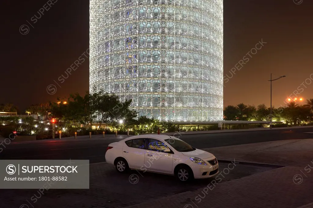 Burj Qatar, Doha Tower, Doha, Qatar. Architect Ateliers Jean Nouvel, 2012. Night view showing the light system designed by Yann Kersalé, with car.