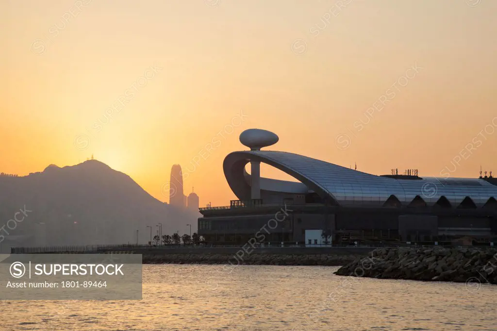 Kai Tak Cruise Terminal, Kowloon, Hong Kong. Architect: Foster and Partners, 2014. View of the Kai Tak Ferry terminal at sunset.