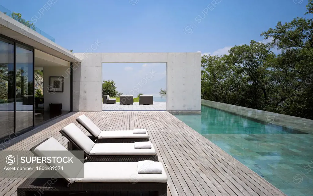 Casa Monterrey, Monterrey, Mexico. Architect: Tadao Ando, 2013. View around pool with sun loungers.