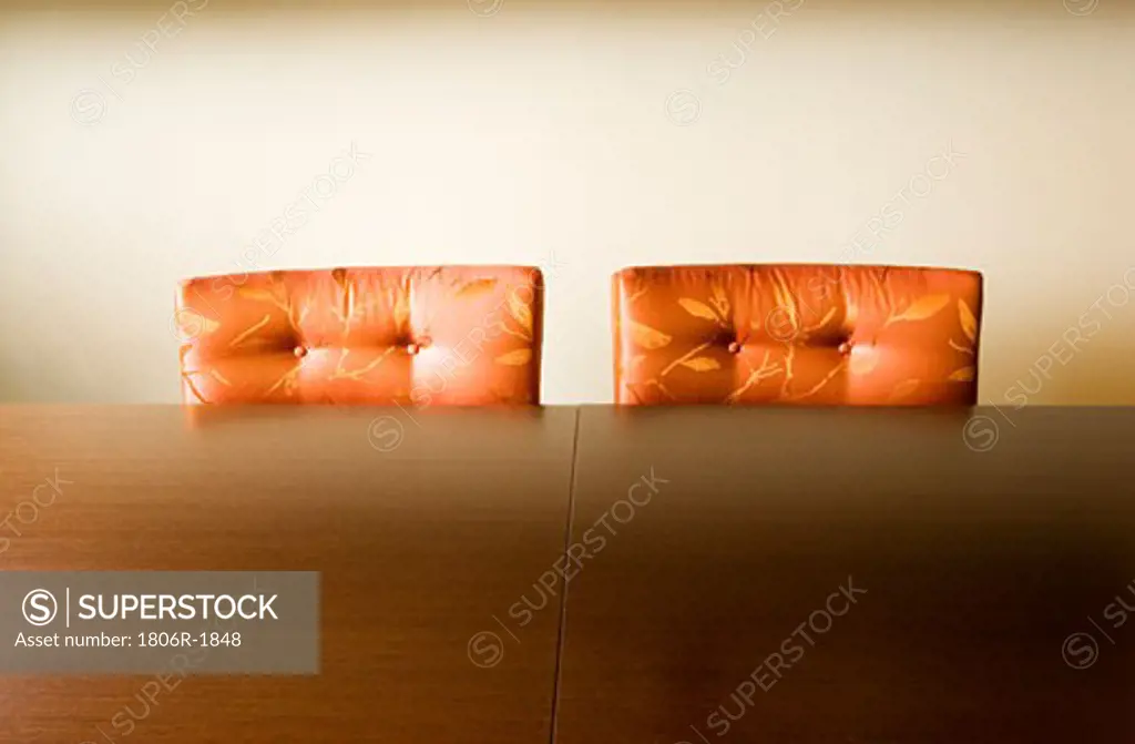 Two Cushioned Orange Dining Chairs