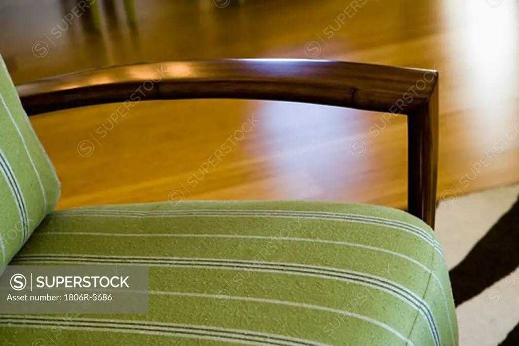 Contemporary Chair with Green Cushion and Wood Arm