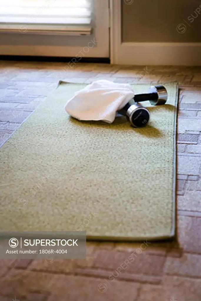 Yoga Mat and Free Weights on Carpet