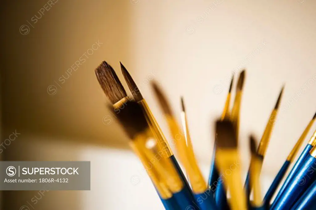 Blue and Gold Paintbrushes in a Jar