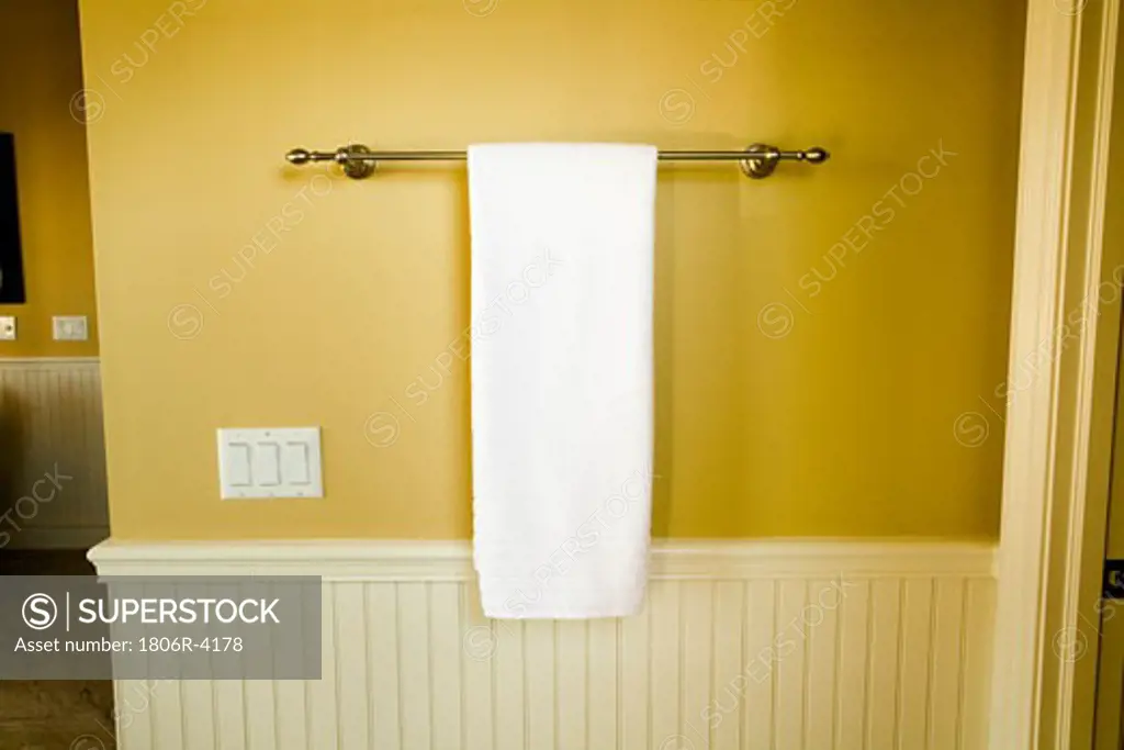 White Towel, Towel Bar, and Yellow Bathroom Wall