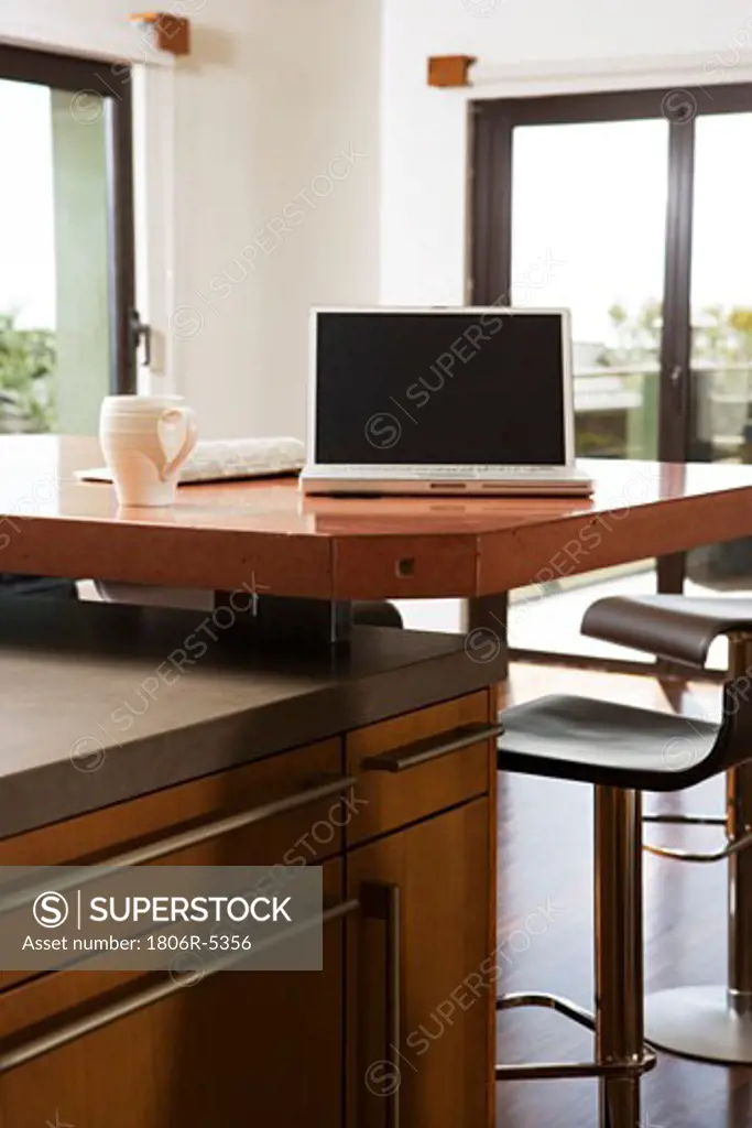 Laptop and Coffee Mug on Kitchen Counter