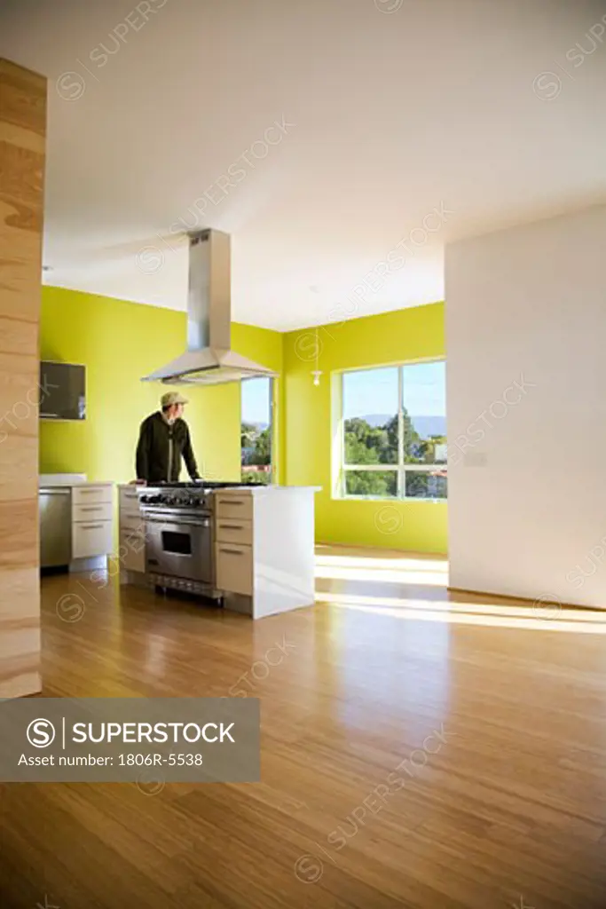 Man Standing in Modern Kitchen