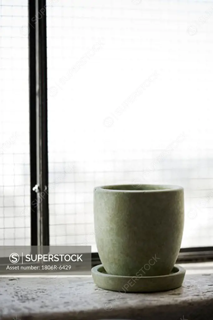 Desaturated green cup on saucer.