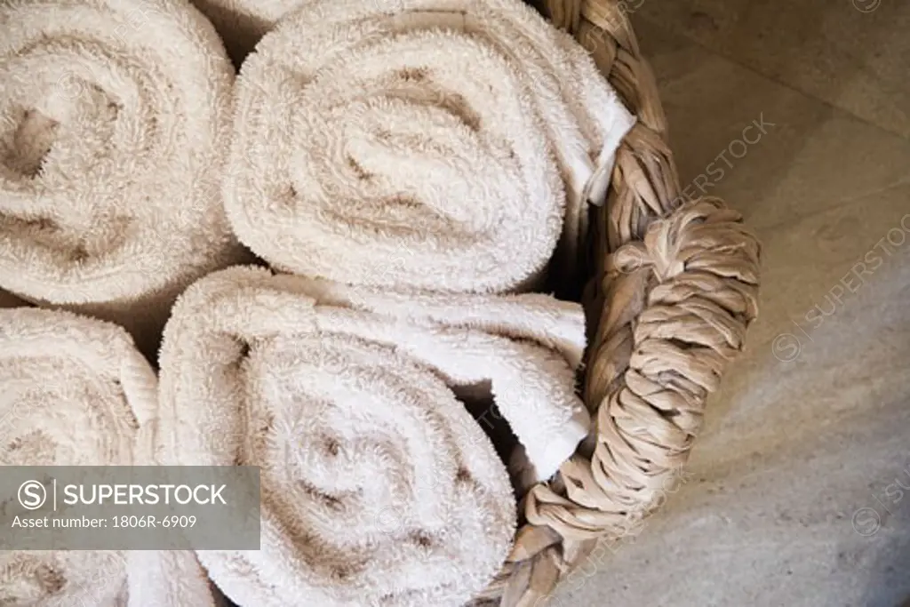 Detail of rolled towels in basket.
