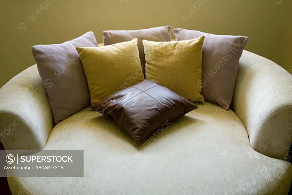 Circular sofa bed with throw pillows