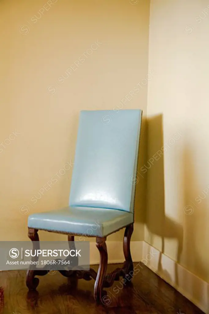 Antique blue chair in a corner