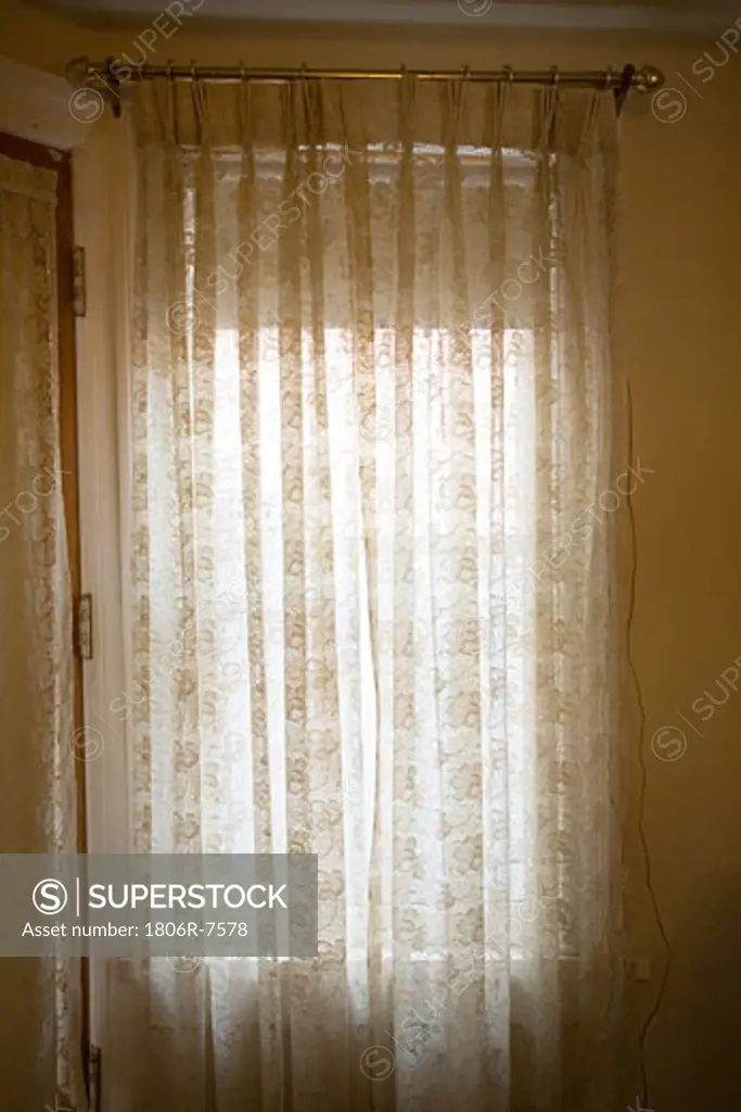 White curtain drawn over the window
