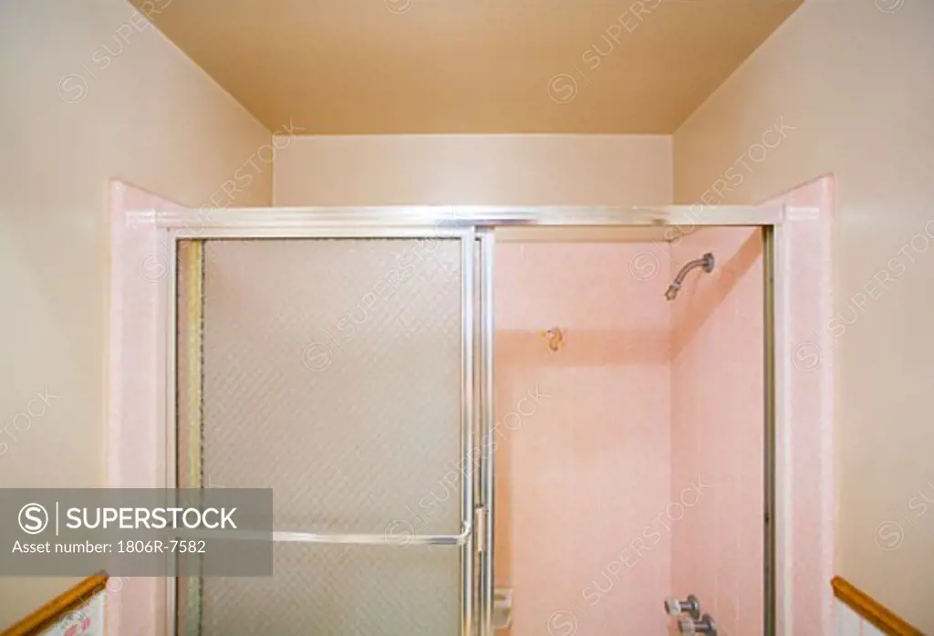 Small bathroom with a pink shower