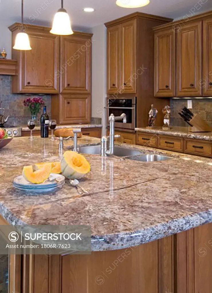 Kitchen with island and marble countertops