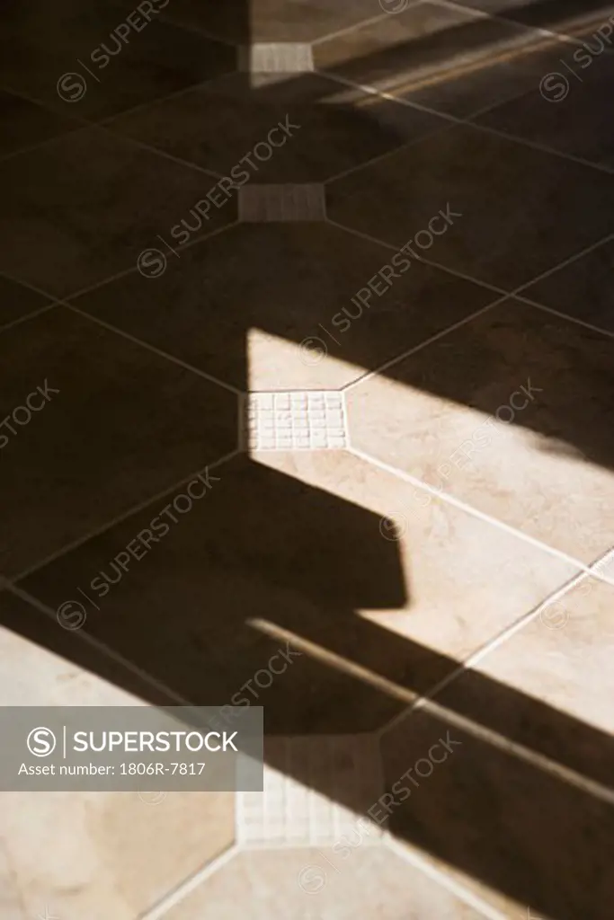 Shadows from window on tile floor