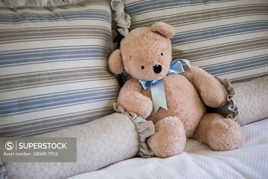 Stuffed bear on bed
