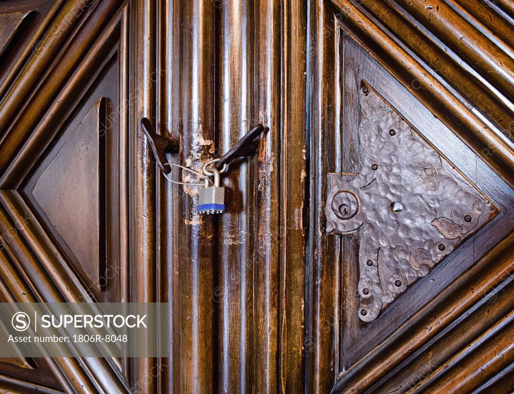 Close up contemporary lock on old wooden door