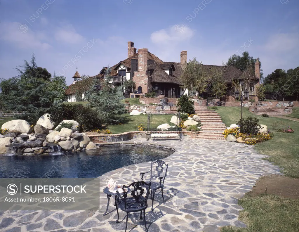 Large cottage with pond and stone walkway