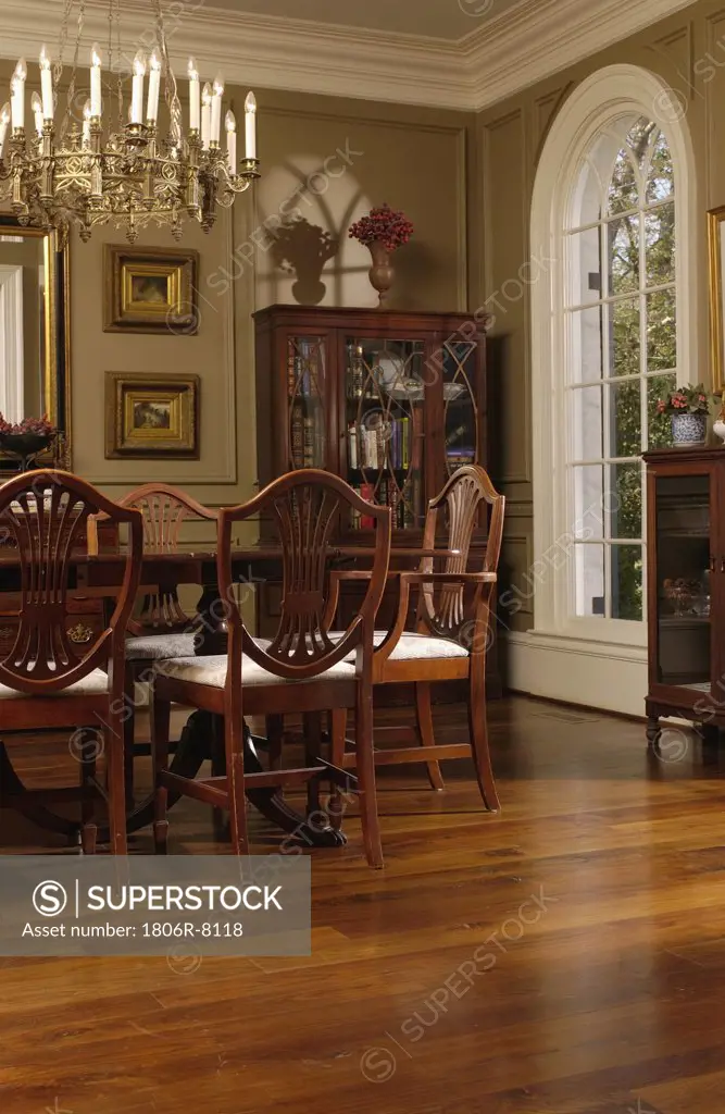 Elegant dining room with oak hardwood floors and Hepplewhite style dining chairs
