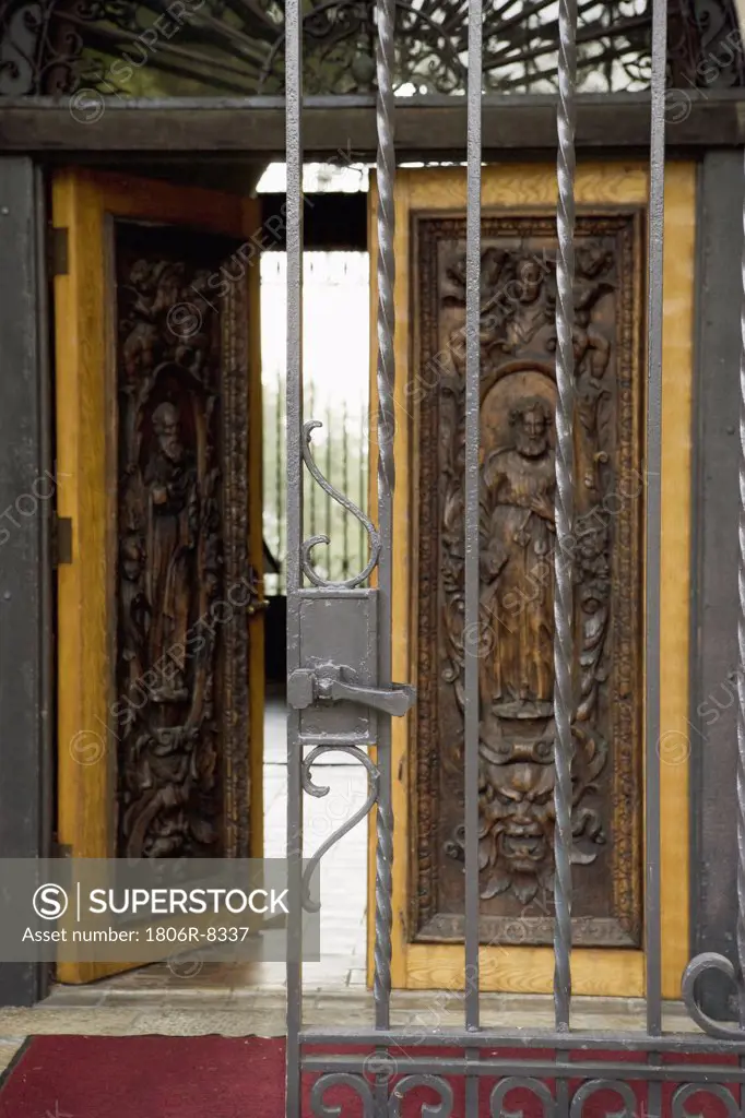 Wrought iron gate and hand carved wooden door