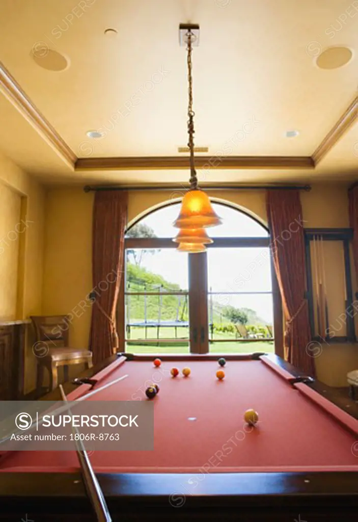 Red Pool Table and Balls with Overhead Lights and Window