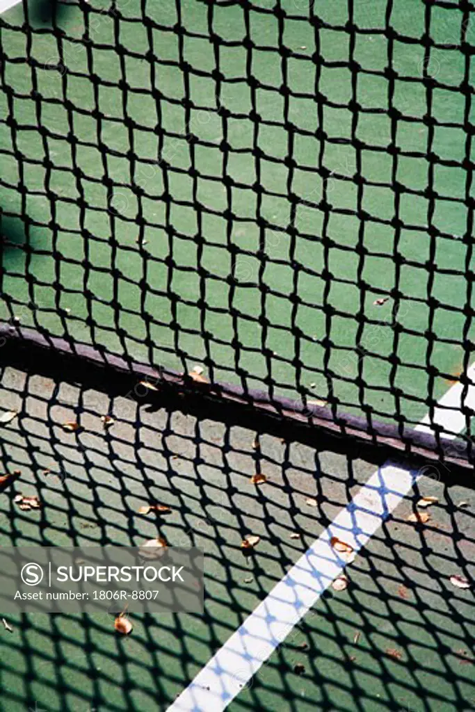 Detail of net and shadow on tennis court