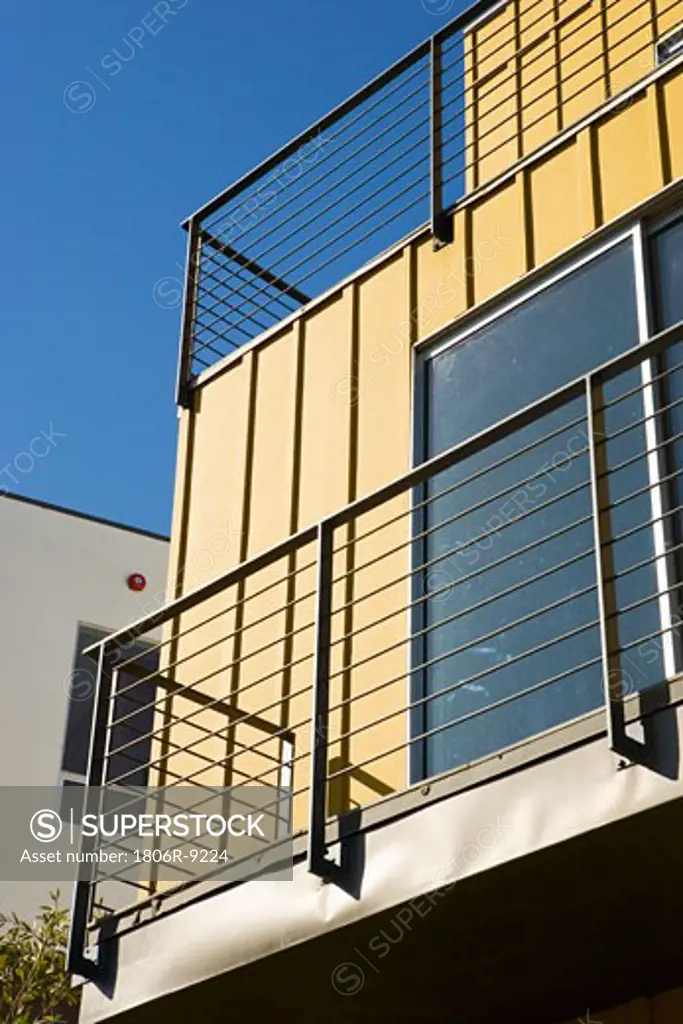 Exterior Detail of Modern Home and Balcony with Yellow Wall