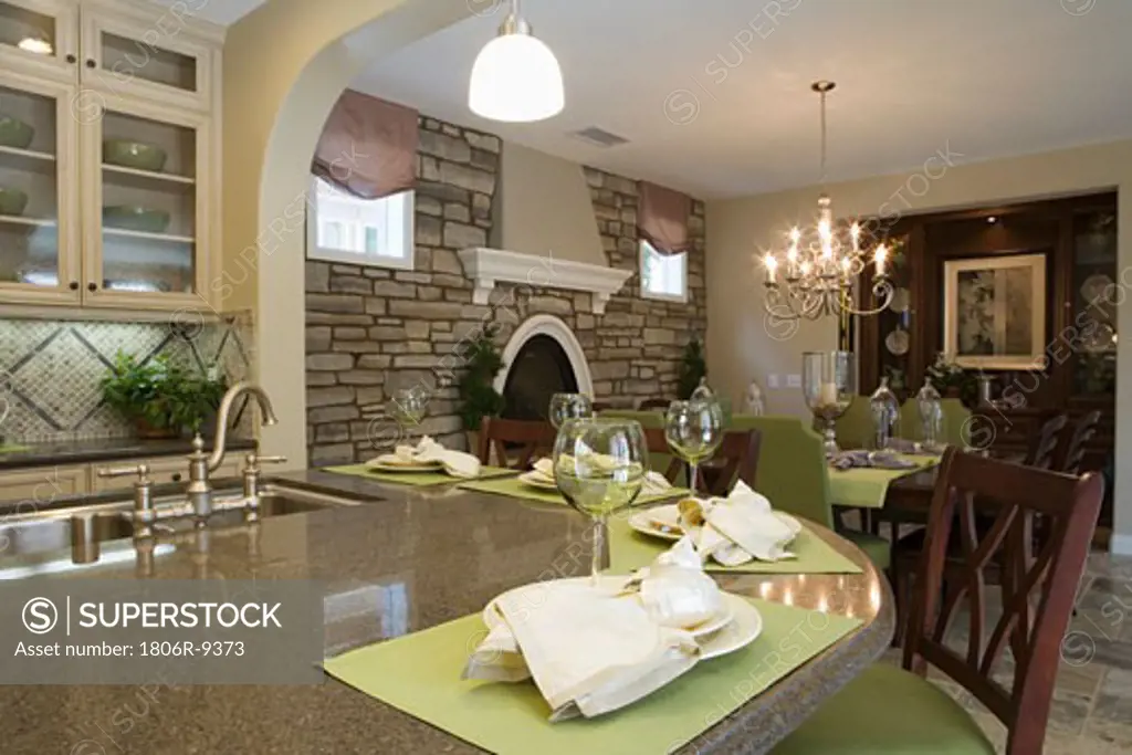 Kitchen with breakfast bar and dining room with stone wall