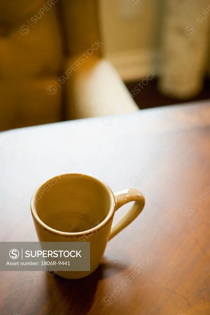 Empty coffee mug on wooden dining table
