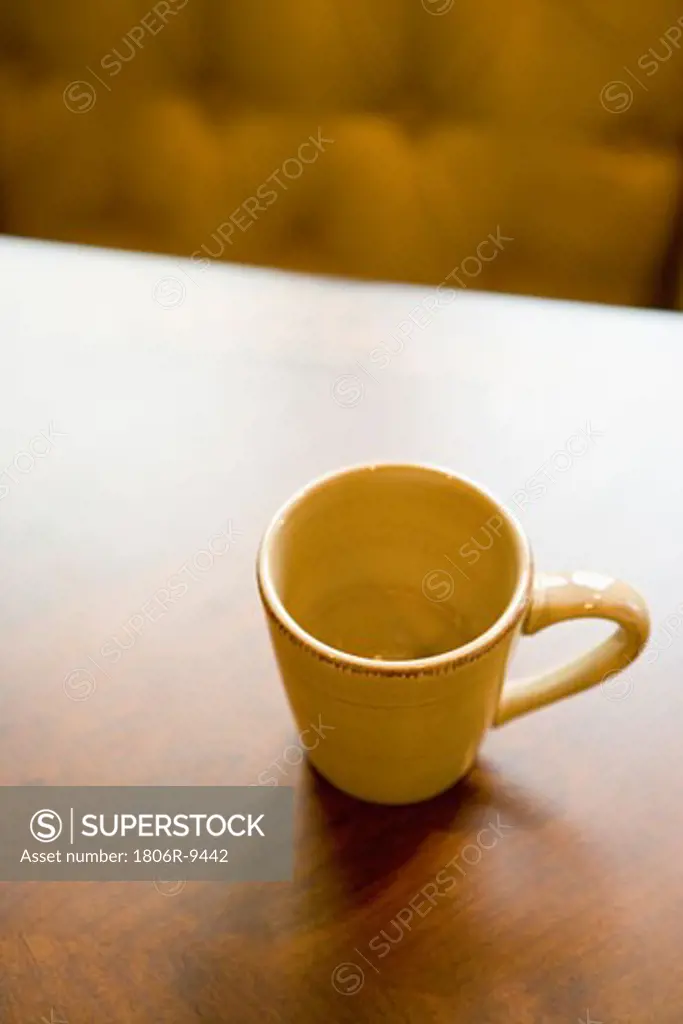 Empty coffee mug on wooden dining table