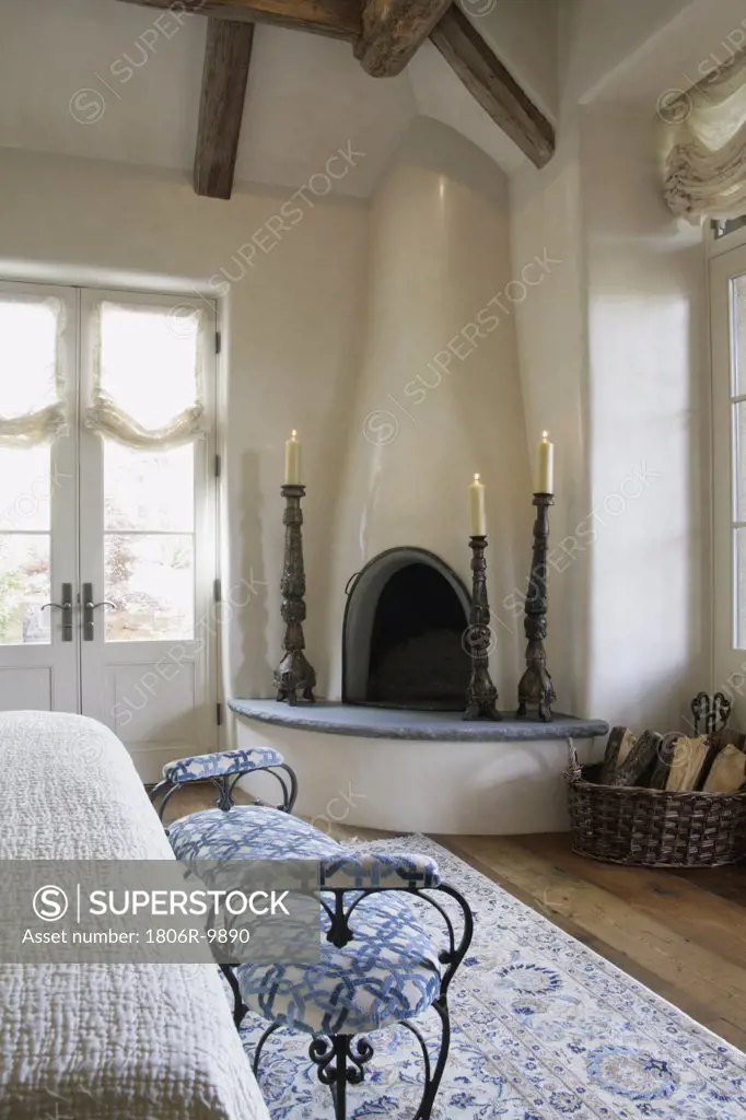 Kiva fireplace in corner of bedroom