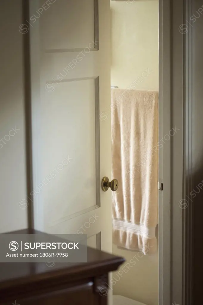 Bathroom door open to reveal a towel