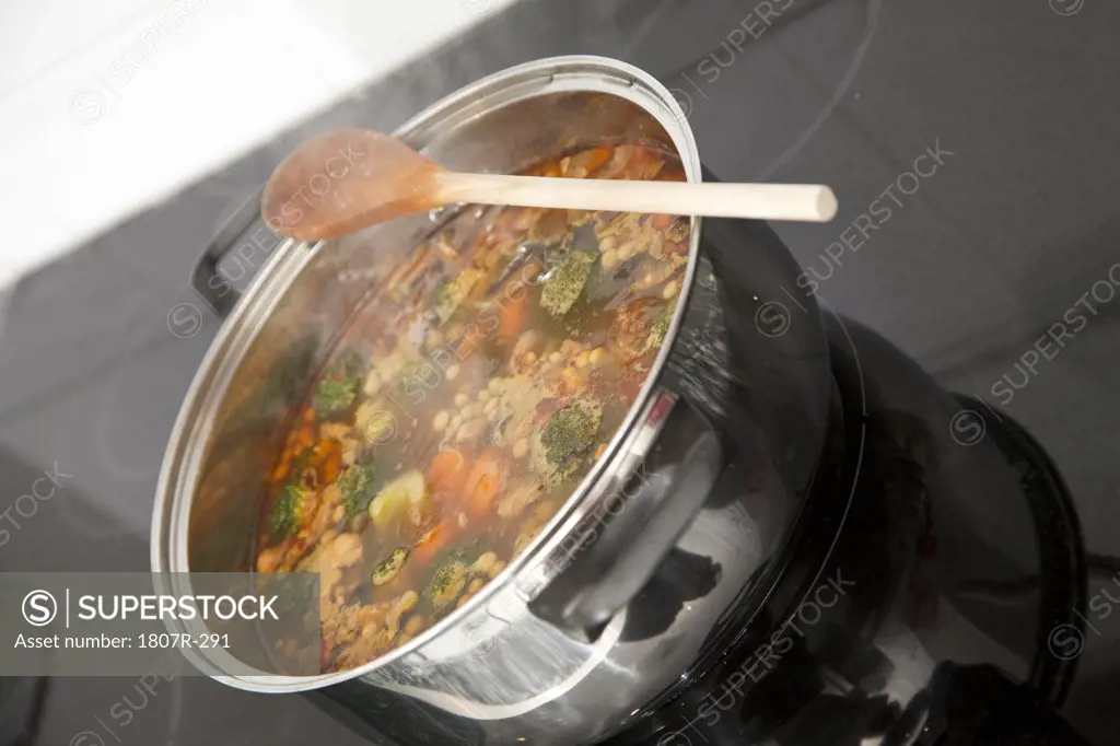 Boiling casserole of soup on a stove