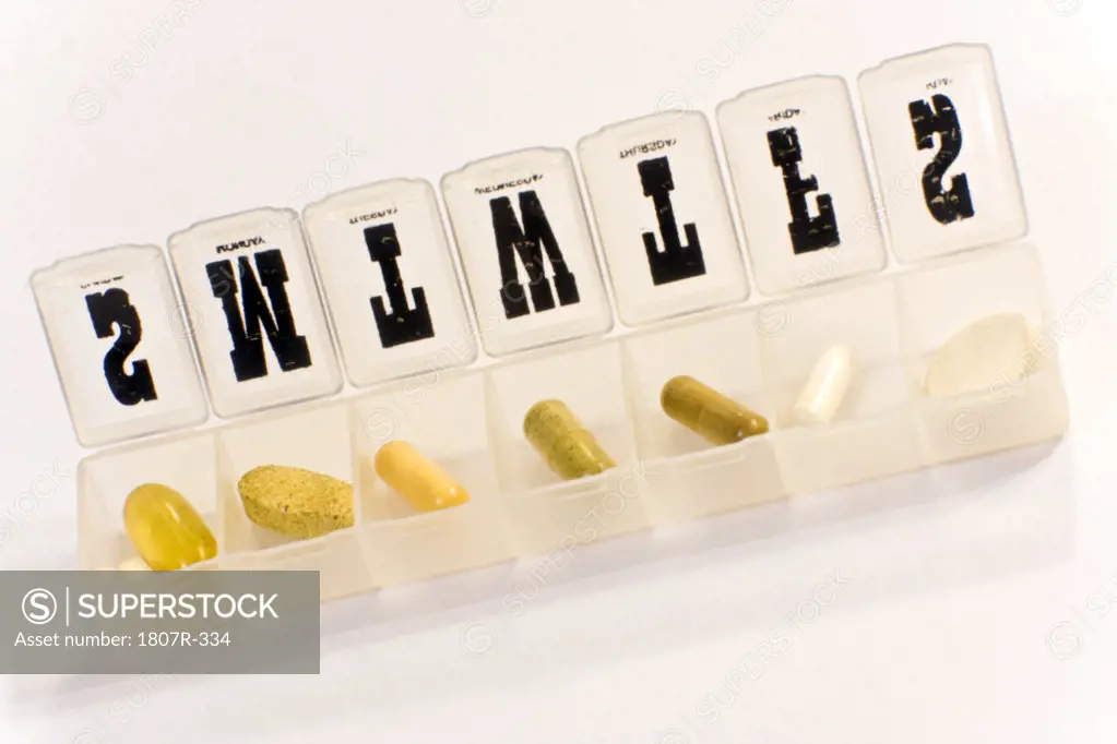 Plastic pill sorter box and pills