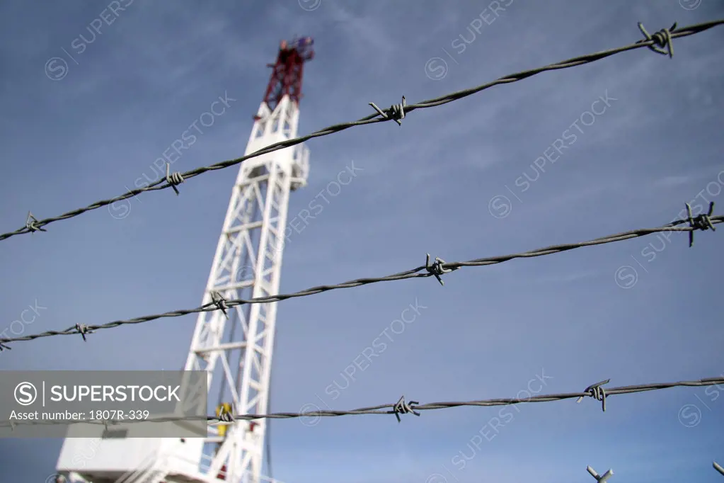 Drilling rig fenced with barbed wire