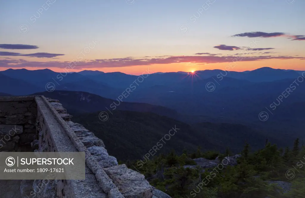 Sunset from Middle Sister Mountain in Albany, New Hampshire USA during the summer months. Remnants of the old Middle Sister fire tower are in the foreground