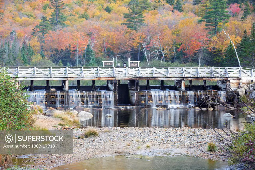 Crawford Notch State Park - Reflection of dam along the Saco River at the Willey House Historical Site in the White Mountains, New Hampshire USA during the autumn months