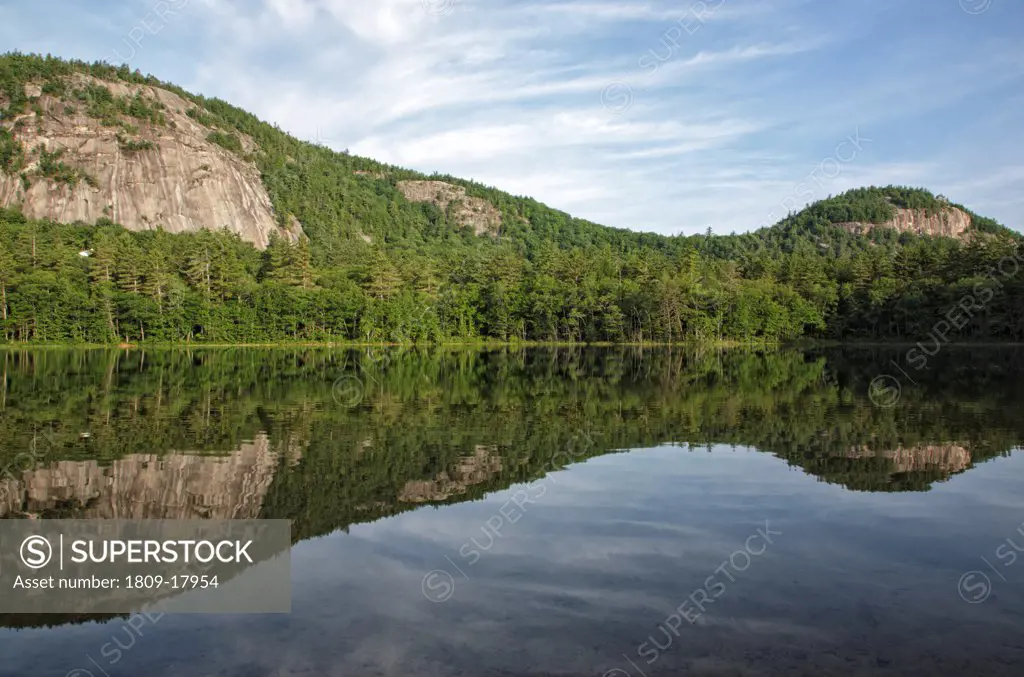 Reflection of Whitehorse Ledge in Echo Lake from Echo Lake State Park in North Conway, New Hampshire USA. This a Temperate acidic cliff