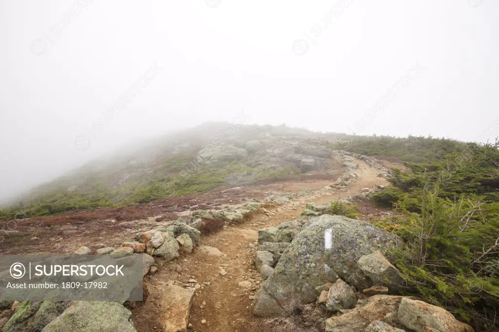 Foggy conditions along the Appalachian Trail (Franconia Ridge Trail) on the summit of Little Haystack Mountain in the White Mountains, New Hampshire USA during the autumn months